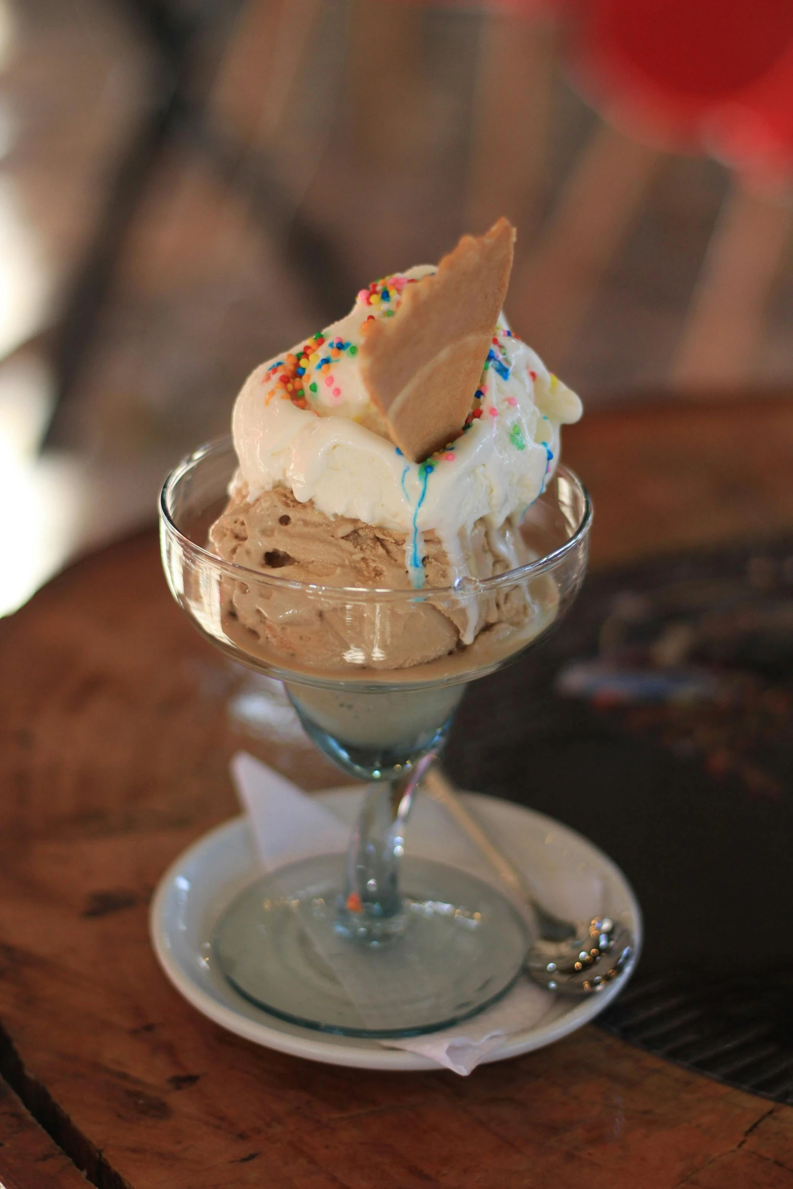 an ice cream sundae with sprinkles in a glass