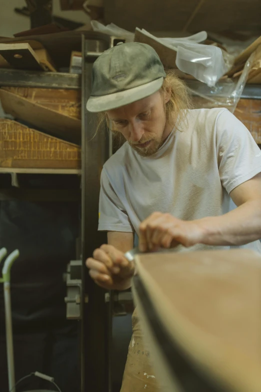 a man working in a workshop with a saw