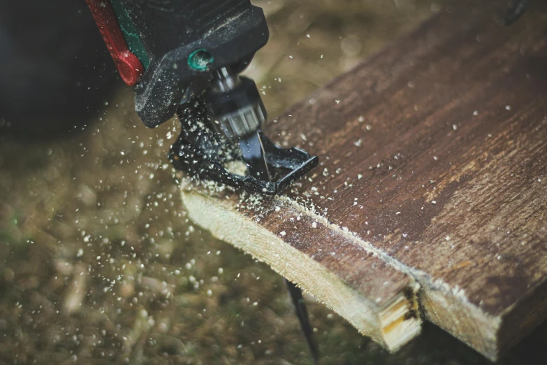 a power drill cuts wood using a cordless nailer