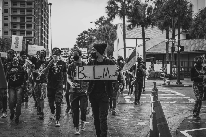 a group of protesters marching in the streets in protest