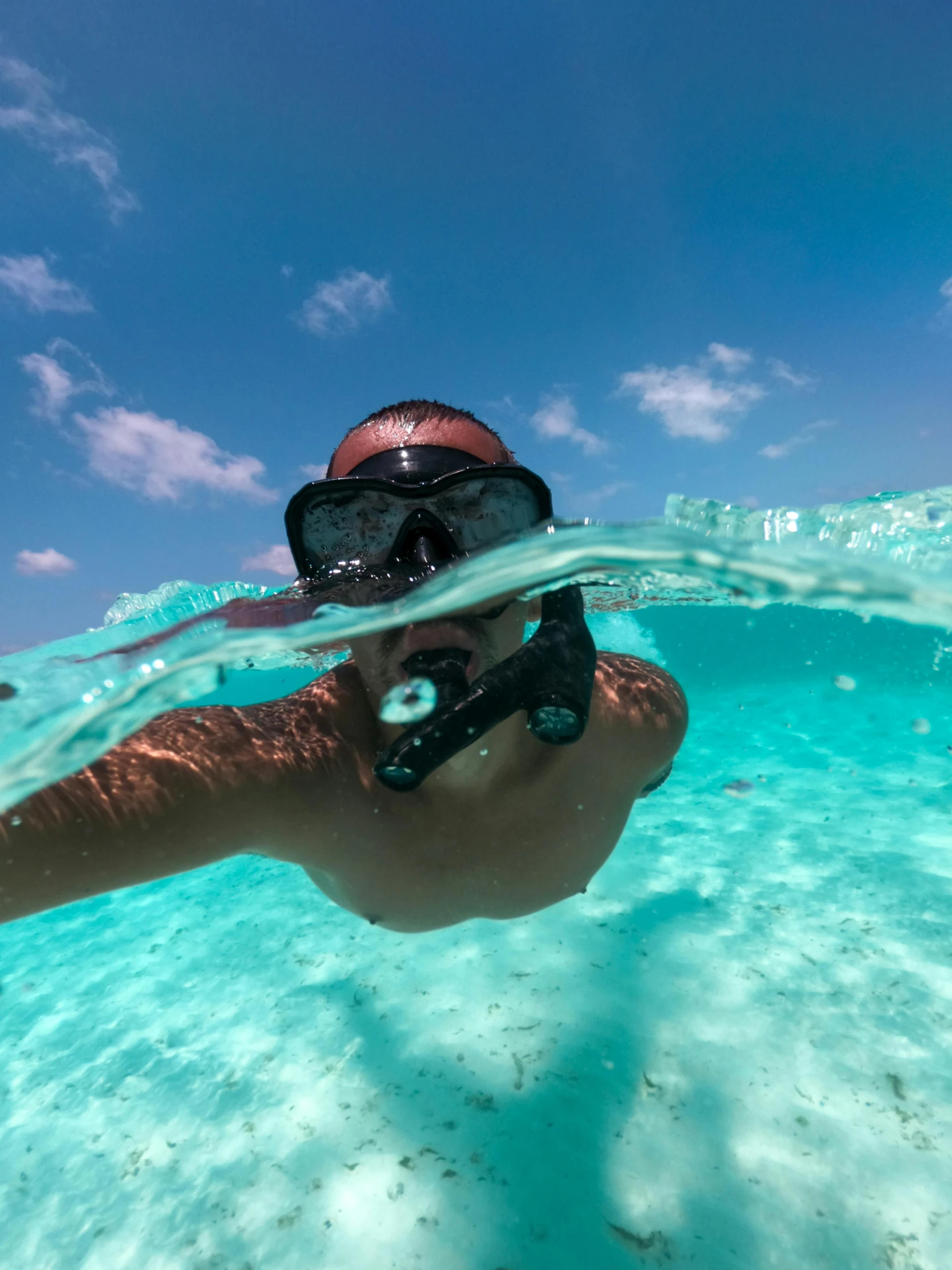 someone is snorkling in the water on a blue day