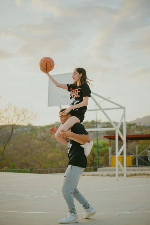 a man on a basketball court and another man holding a basketball