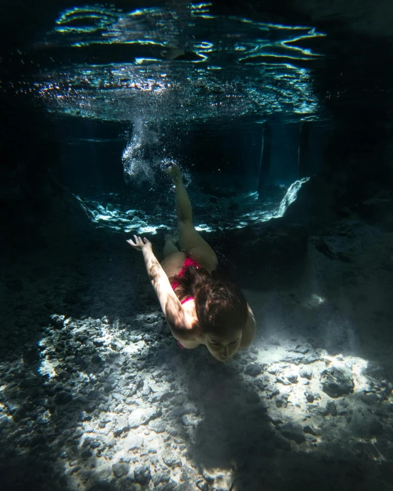 a young woman swimming in a pool on her stomach