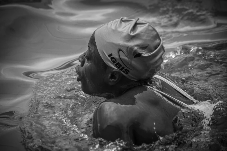 the man is wearing a hat in the water