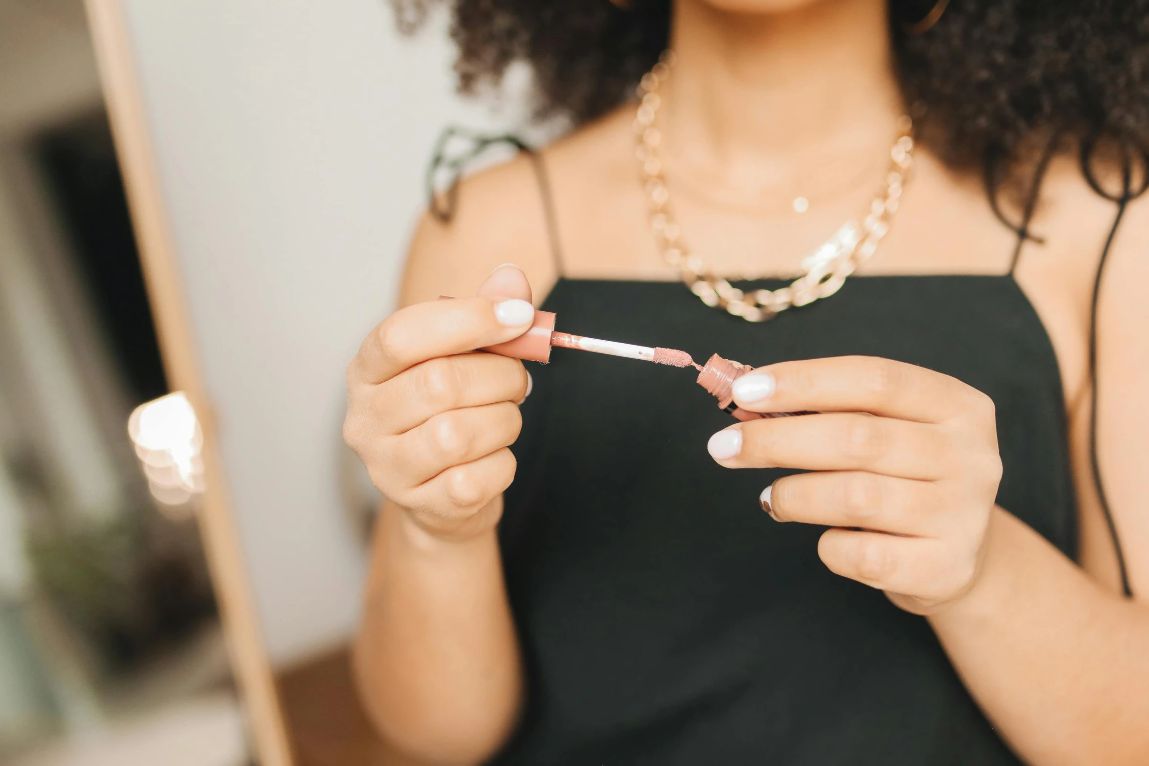 a person brushing their nails in front of a mirror