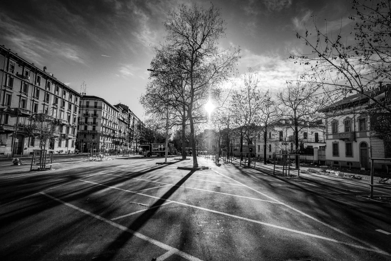 an empty city street with the sun low