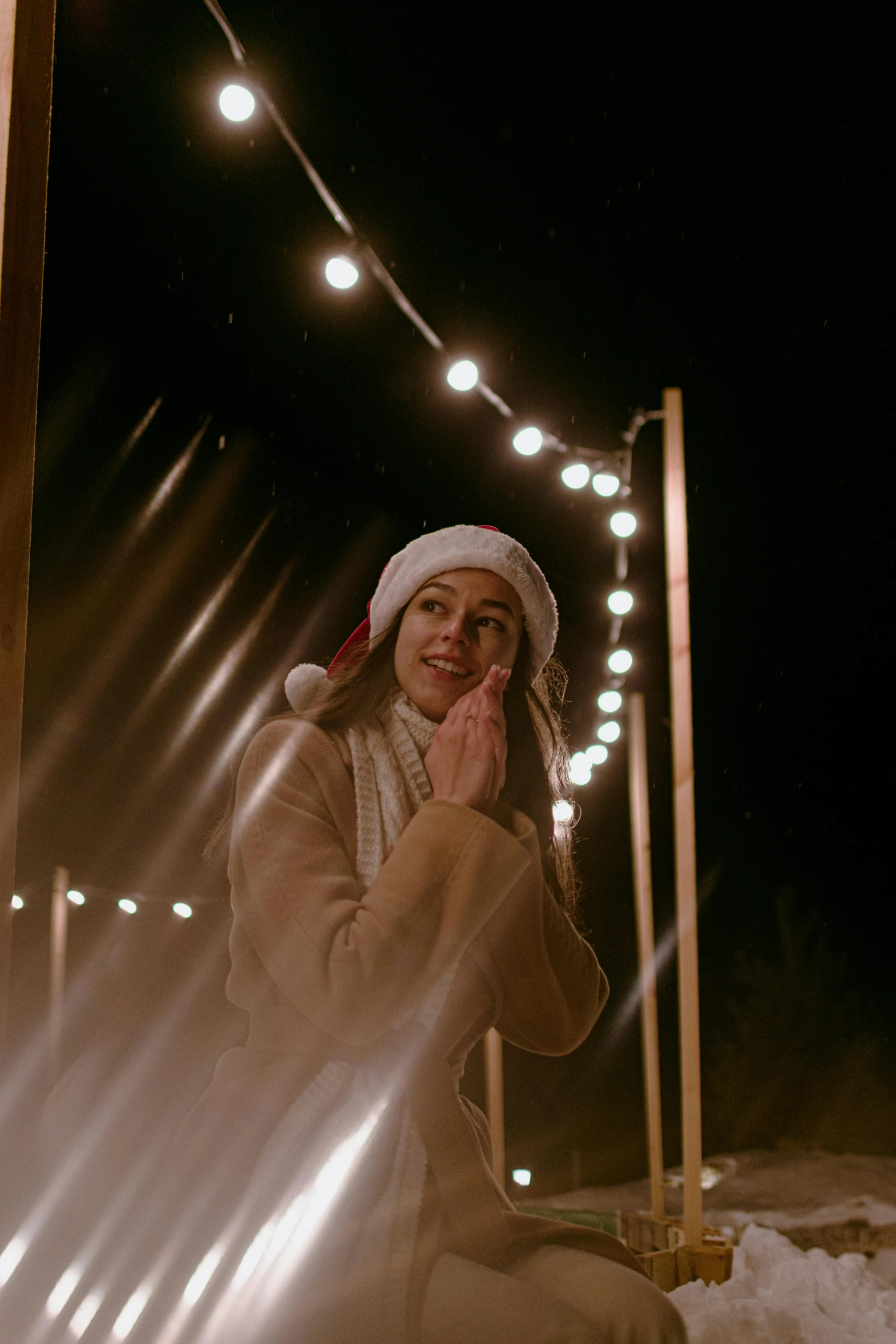 woman with lights on her head sitting in the snow