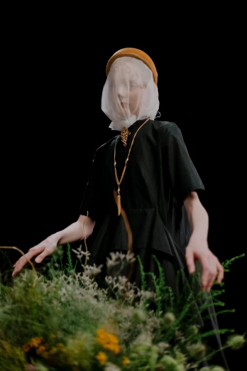 the young person wearing white mask and black dress has large eyes