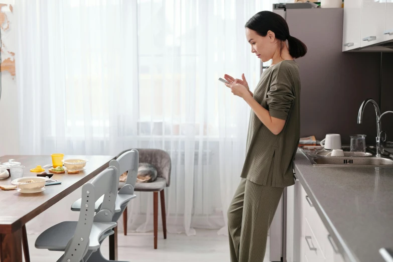 a woman in green standing at the counter