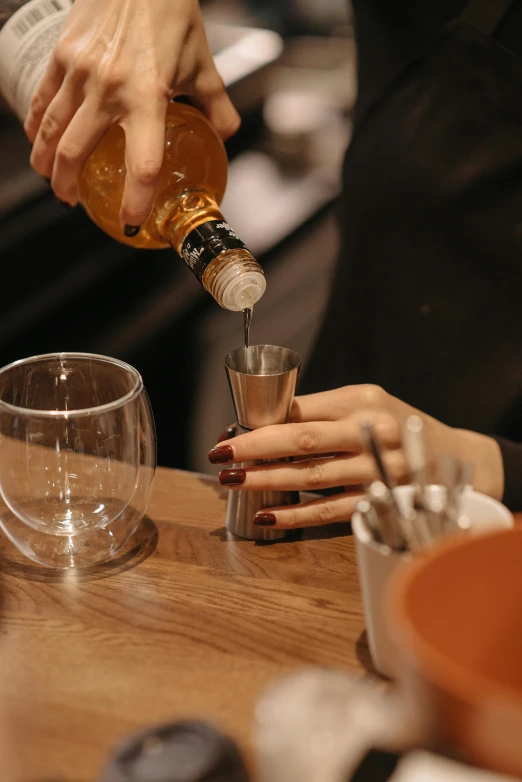 a couple of people sitting at a table drinking