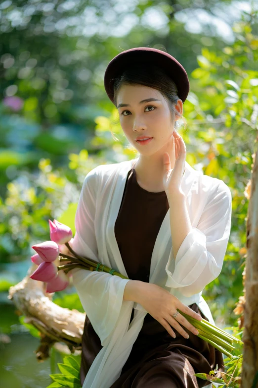 a woman in a dress and hat is posing for the camera