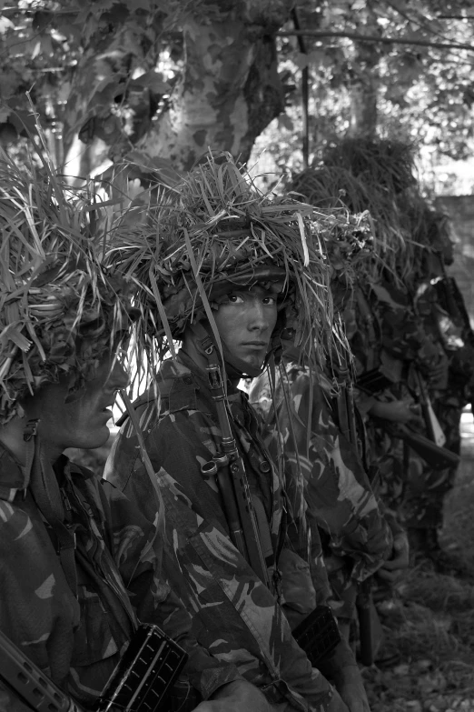 a soldier holding a rifle in his arms as he looks back