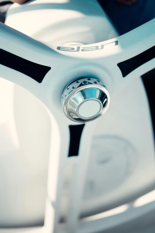 a close up view of a wheel on a white and black motorbike
