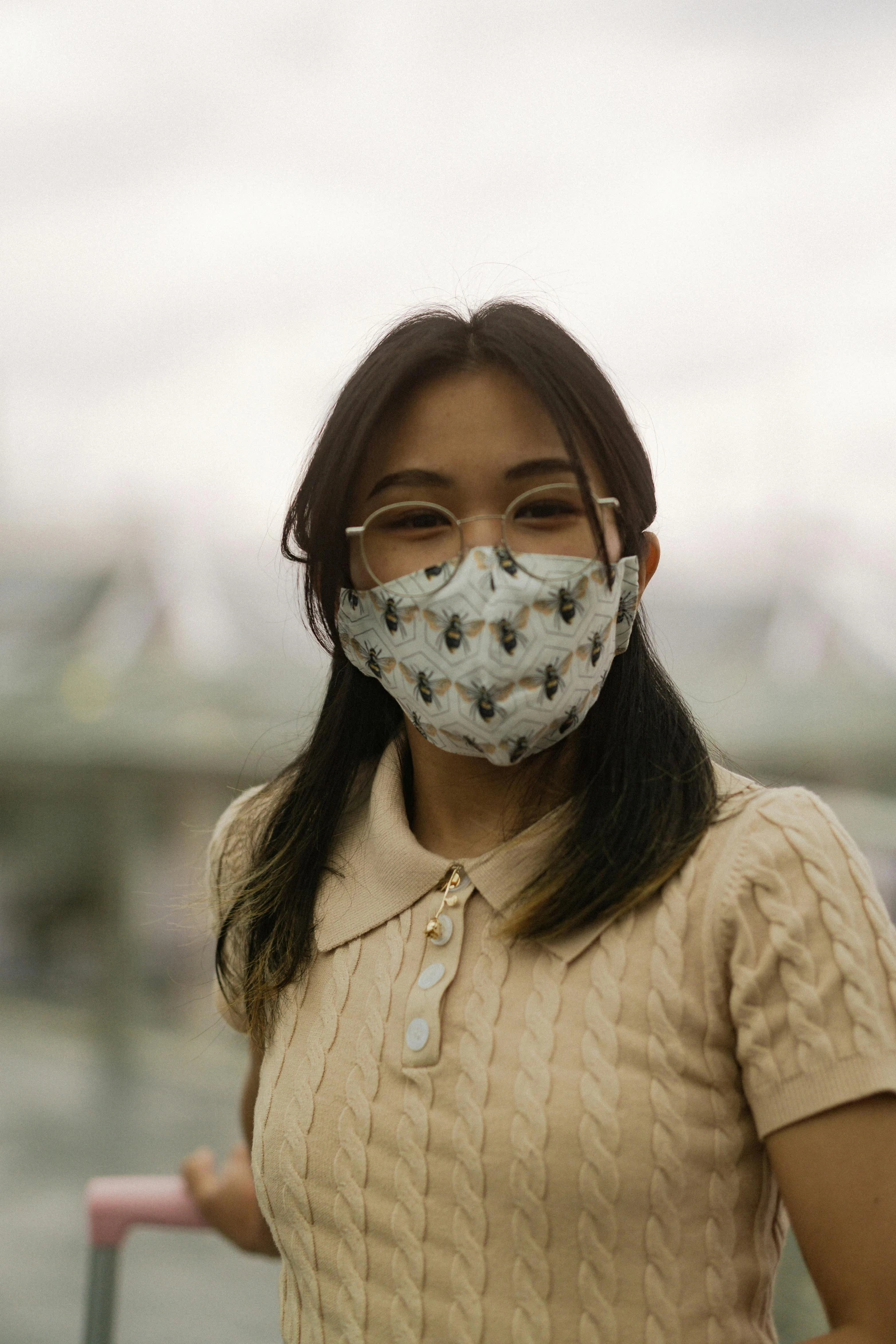 a woman wearing glasses and a face mask