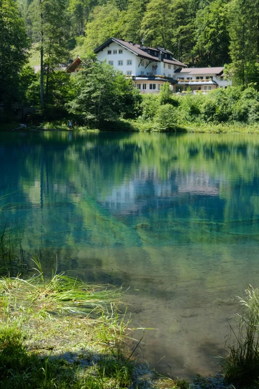 a reflection of a building is in the water