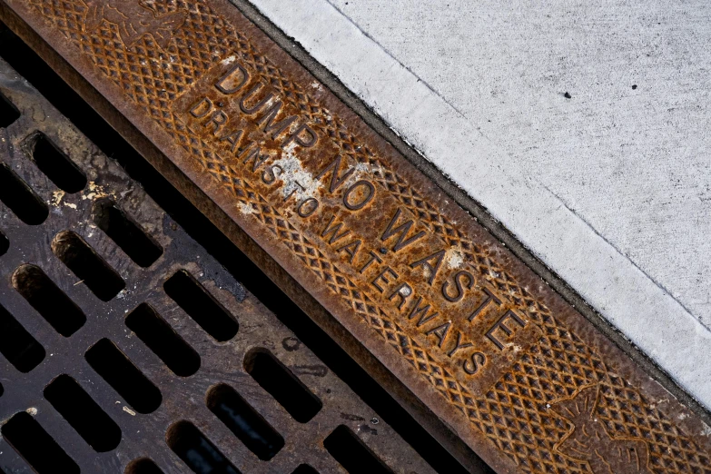 a manhole cover on the side of a city street