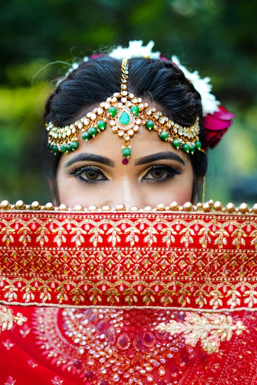 the woman has her face covered by some beads