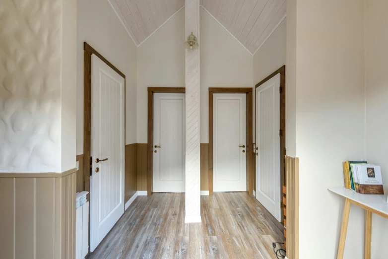 a hallway leads to the bathroom of a home