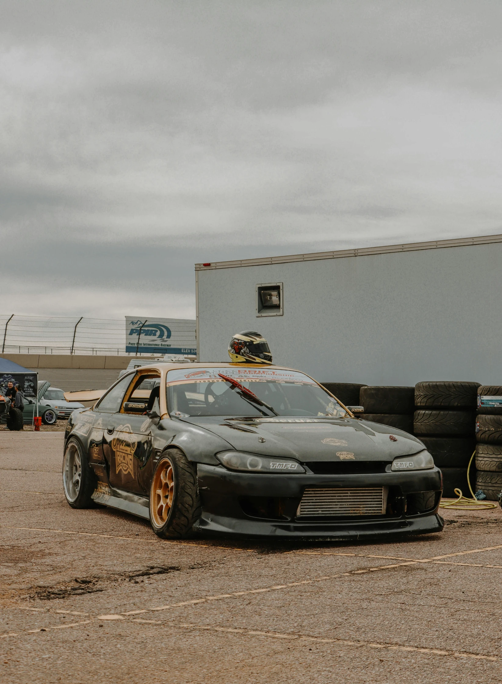 an drift truck parked next to some tires