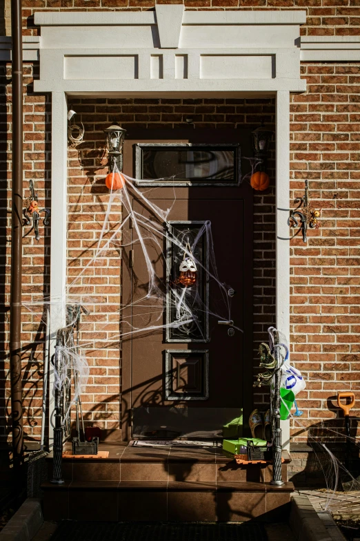 a doorway decorated for halloween with spider web decorations