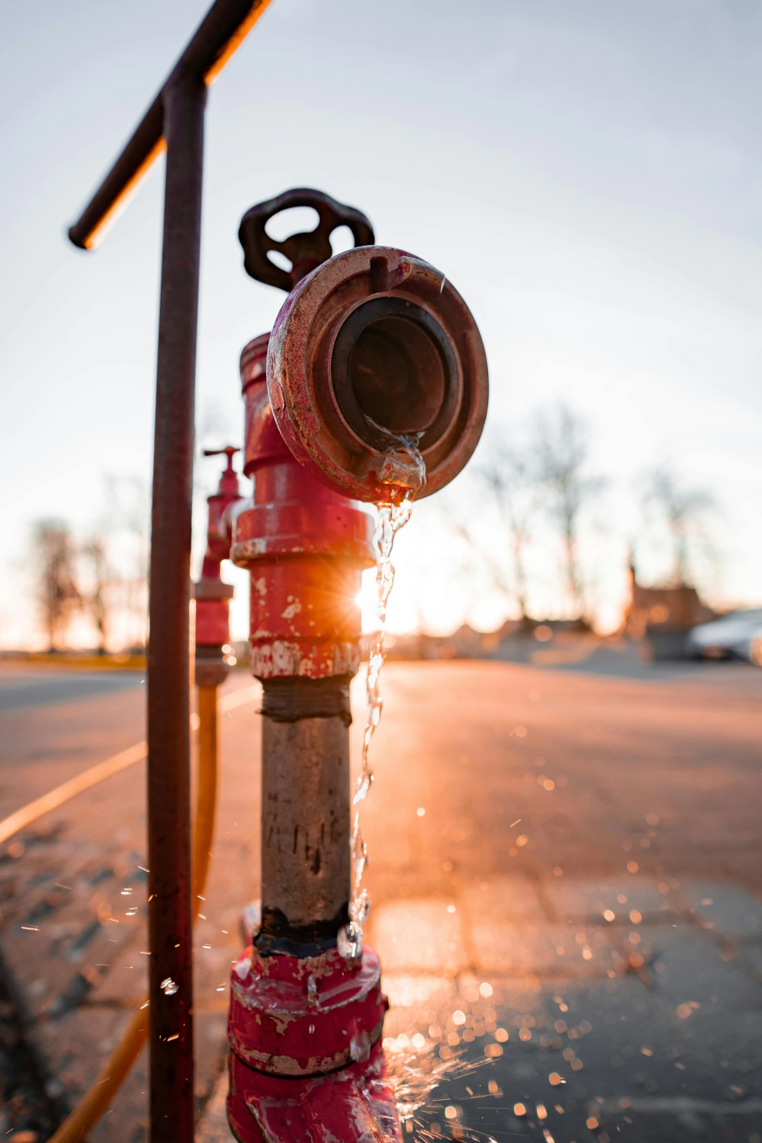 a red fire hydrant that has water running down it