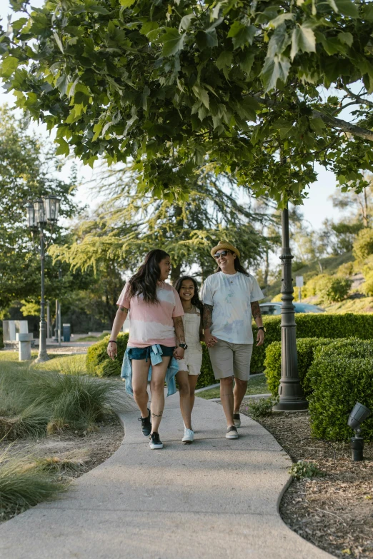 a man and two girls walking in front of a clock