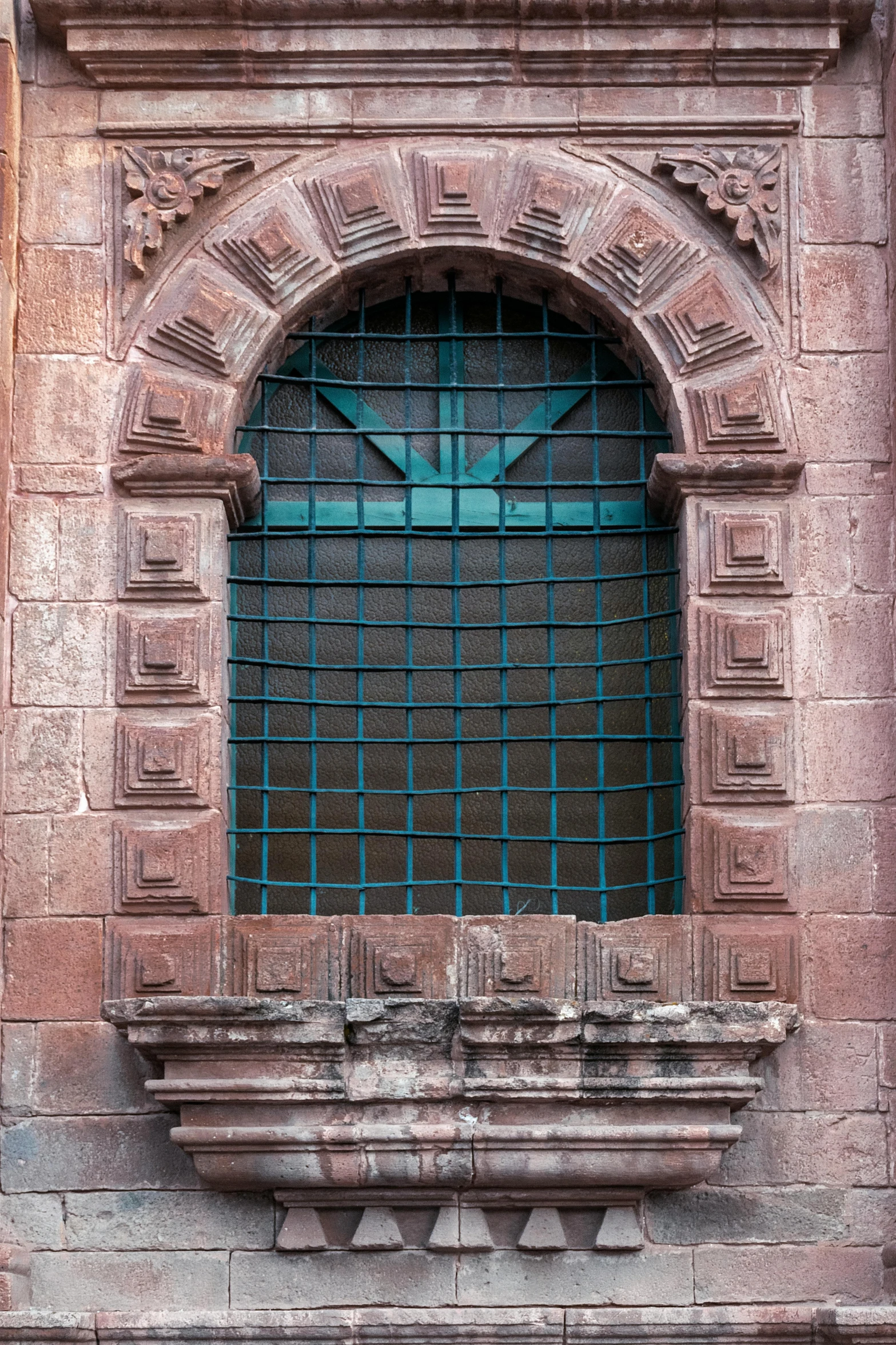 a window with a green steel grid on the top