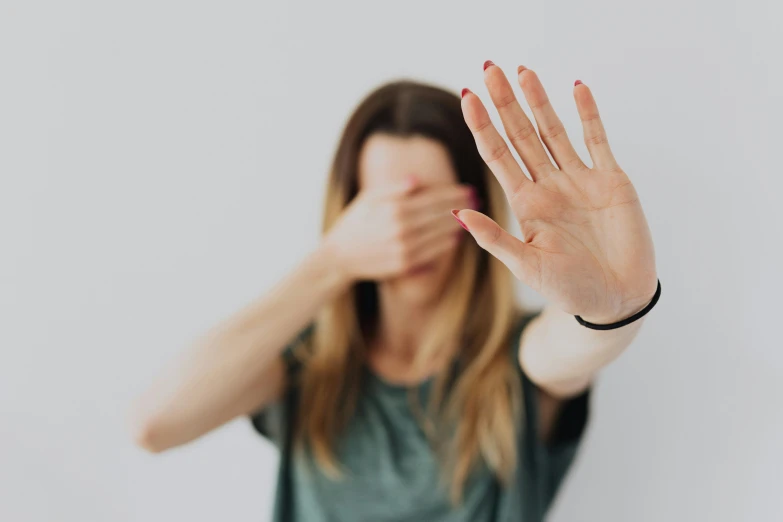 woman with arm extended open on white background