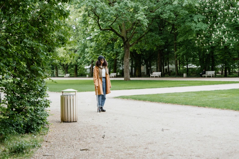 a young woman posing for a picture in a park