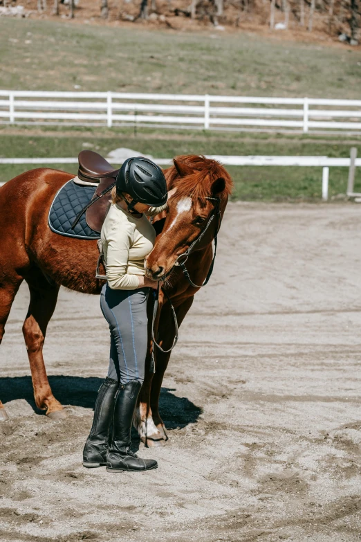 a person with a horse in a dirt field