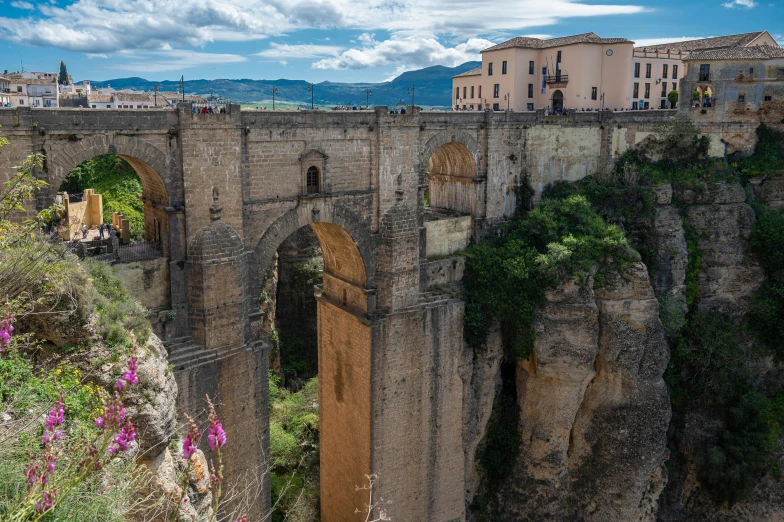 the stone bridge is built high on the side of the mountain