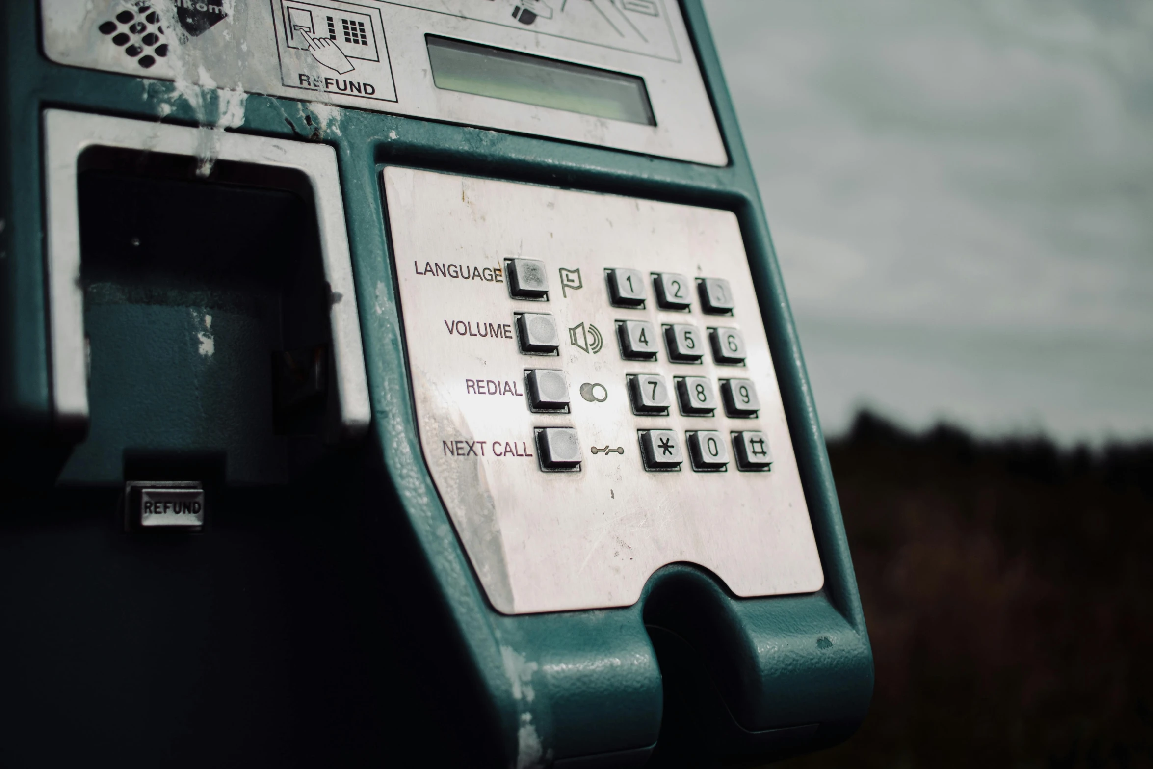 an old style pay phone with numbers and ons