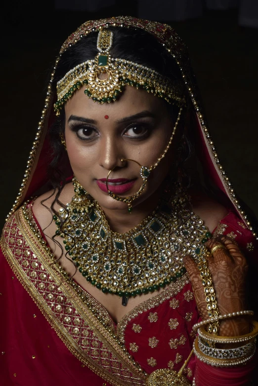 a woman dressed in an indian wedding outfit