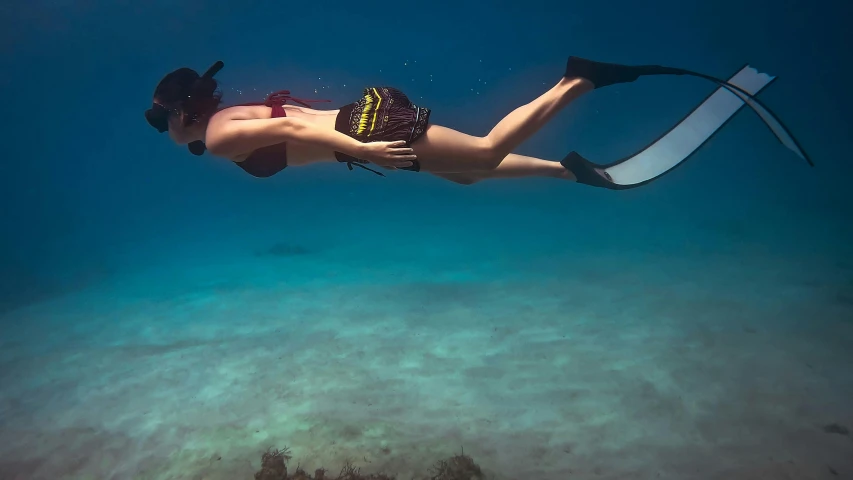 the person is swimming on the water wearing snorkels