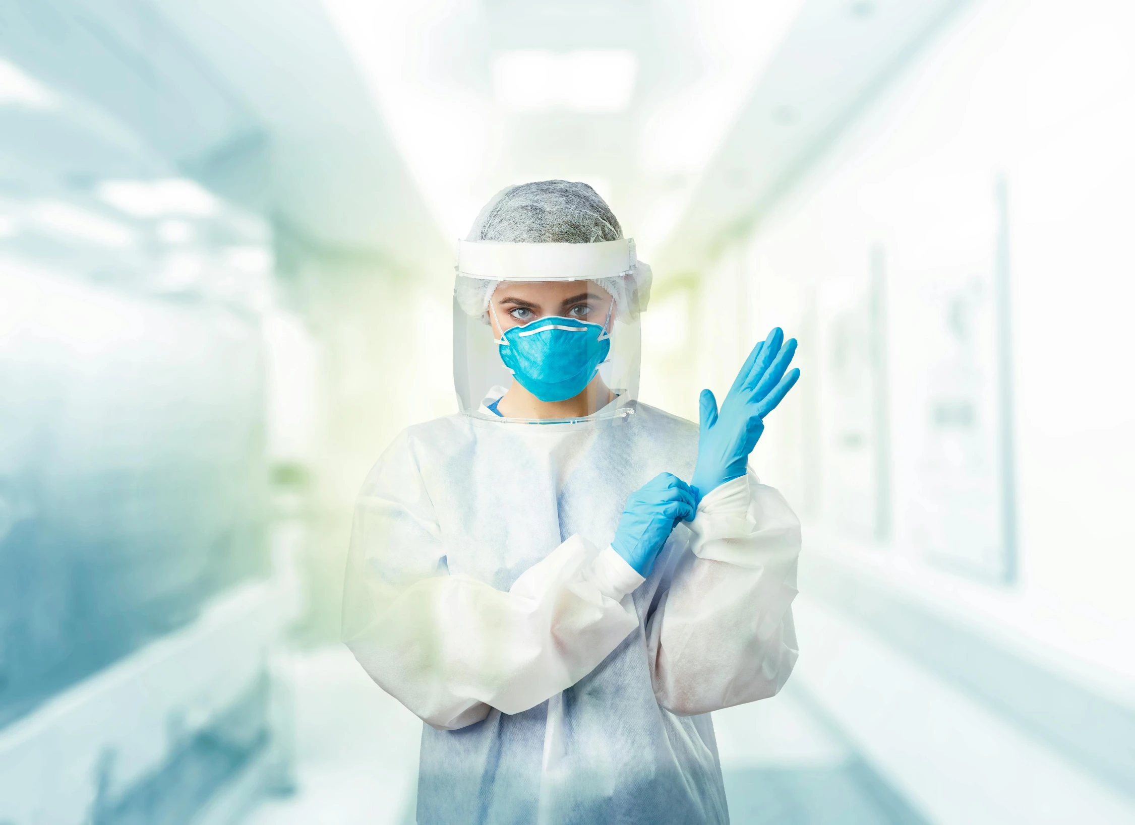 a woman in protective gear holds her hands up