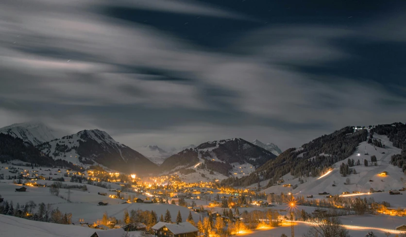 the night sky glows brightly over a snowy town