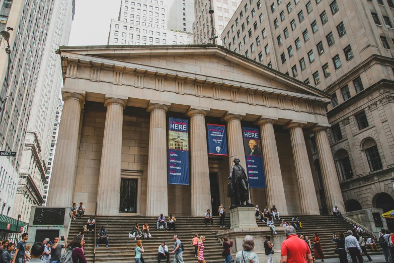 people standing on the steps in front of the building