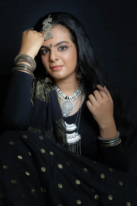 a woman with long black hair and an elaborate head piece