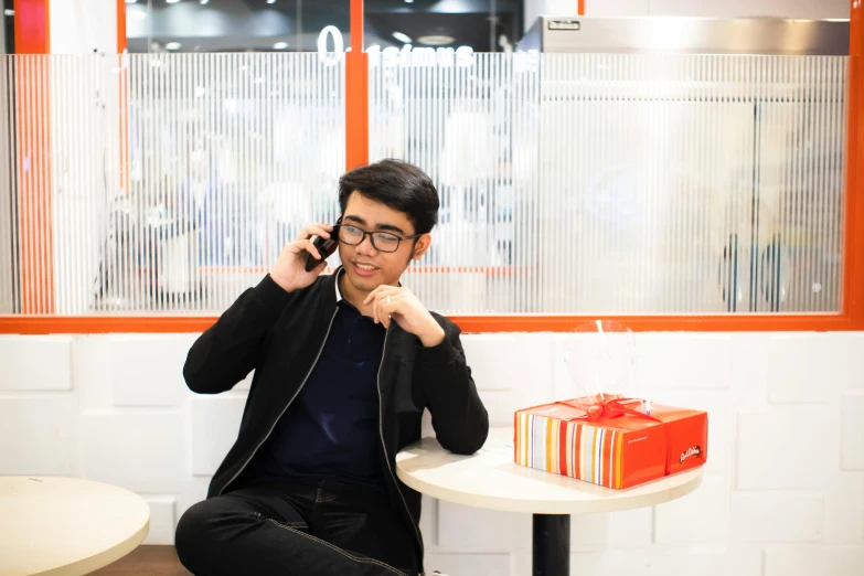 a man sitting on the floor using a cellphone