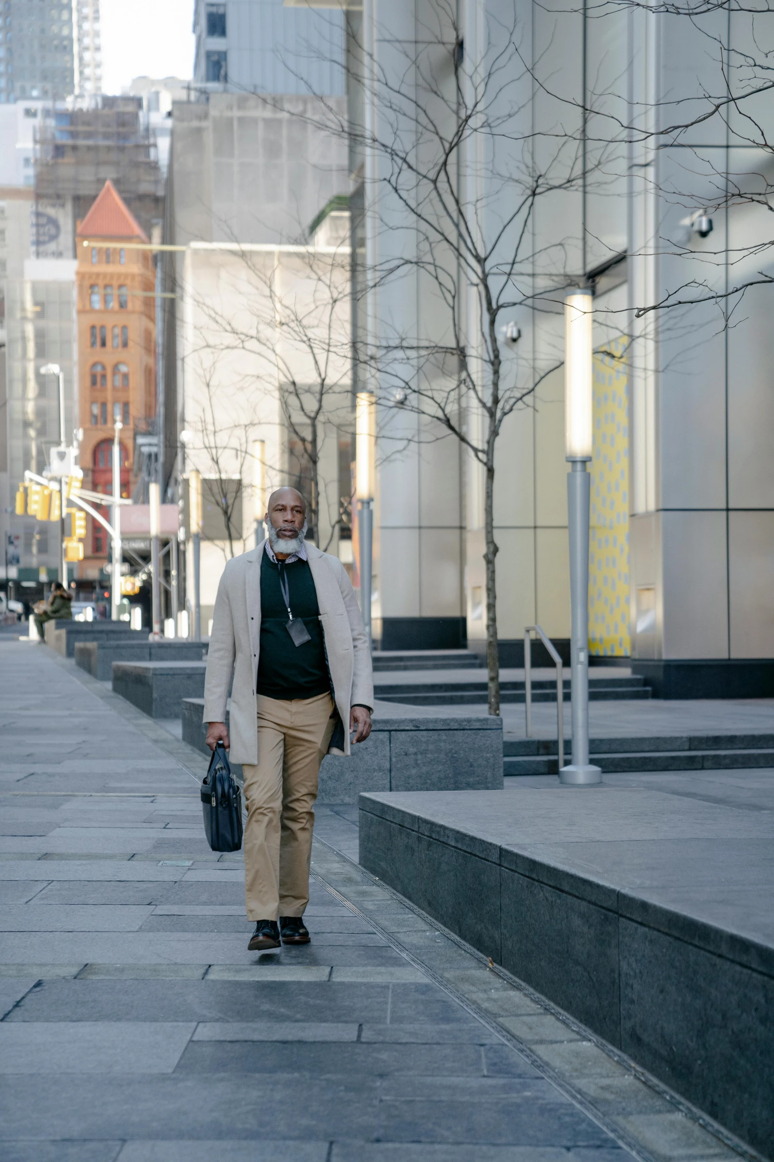 a man walking down a street with a suit case in his hand