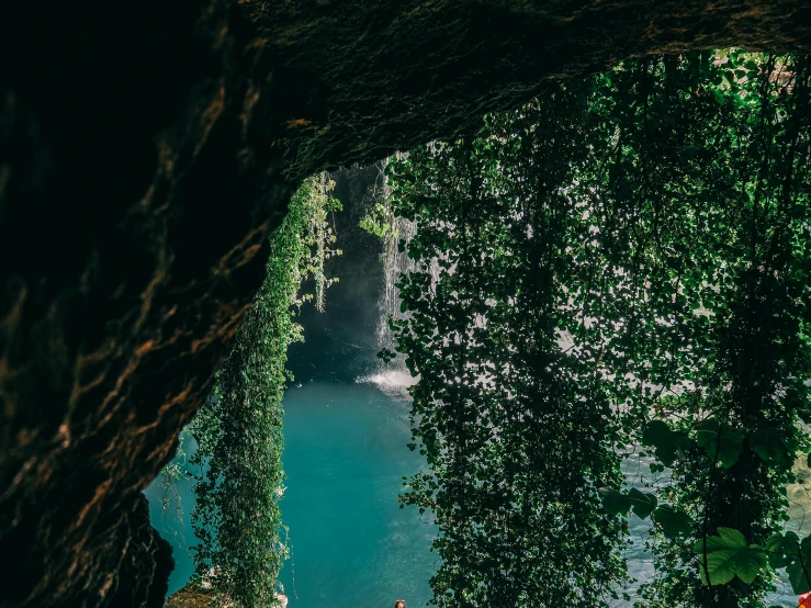 two people in bathing suits are at the bottom of a cliff