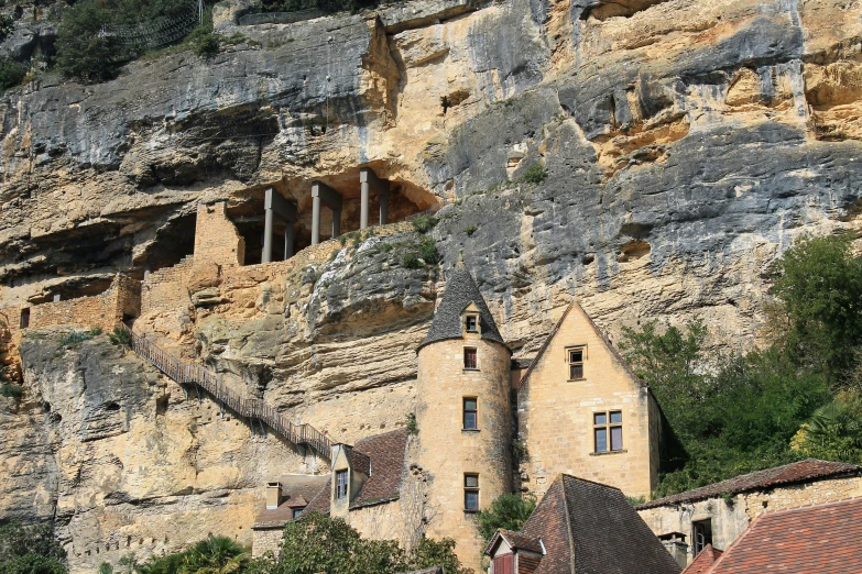 an old building stands on the side of a mountain