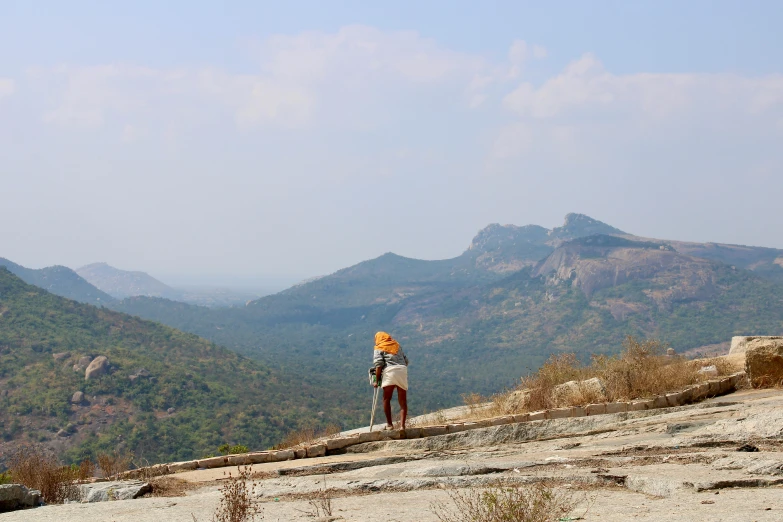 a woman stands with her back towards the view