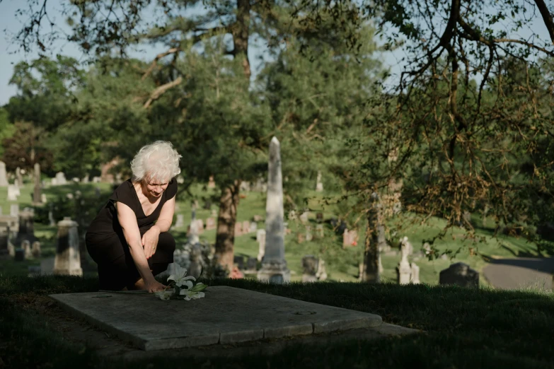 a woman who is sitting on a stone