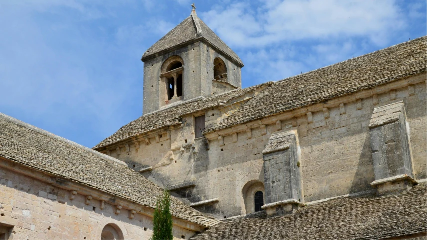 a stone building with a clock and bell tower