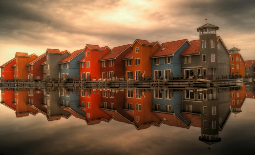 a large group of houses on the side of a body of water