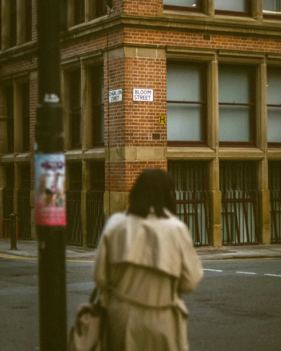 a woman standing on the side of a street