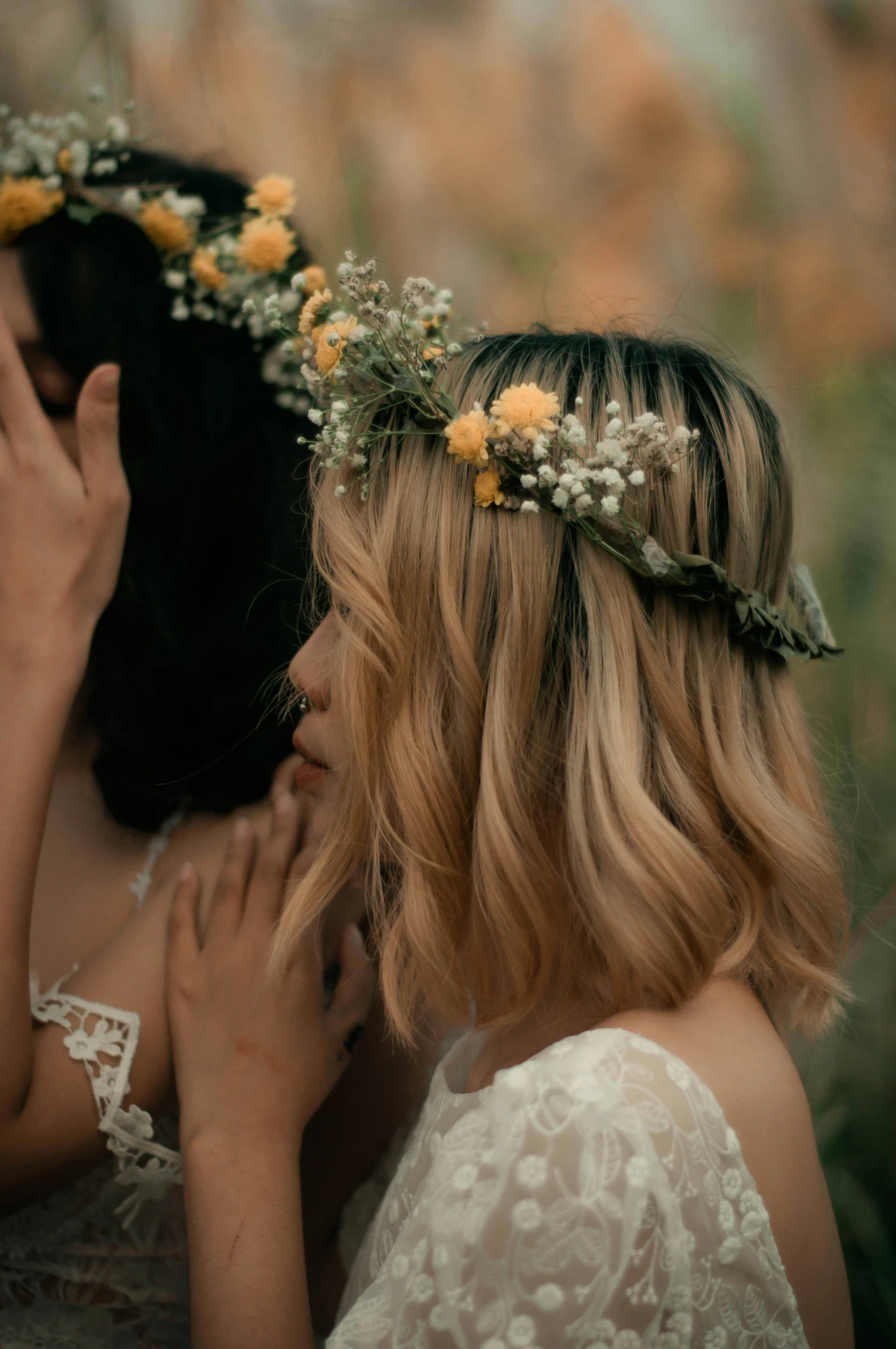 a couple of women wearing flower wreaths over their heads