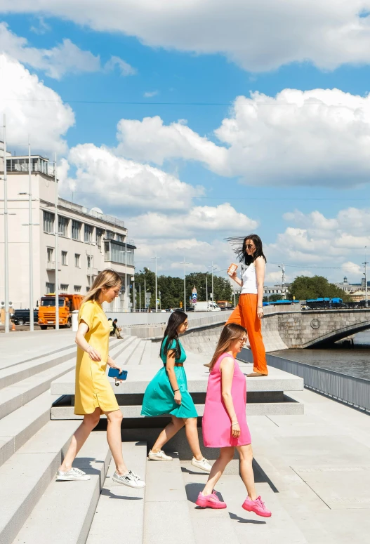 the three young women are walking up steps together