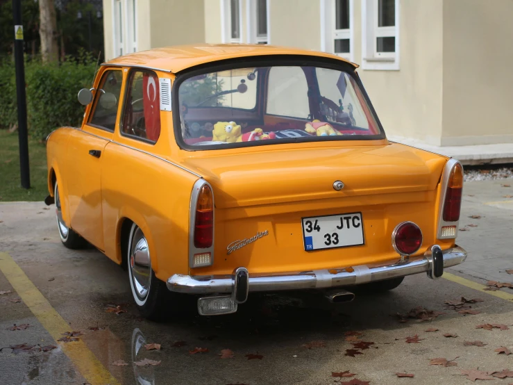 the orange car is parked in the parking lot